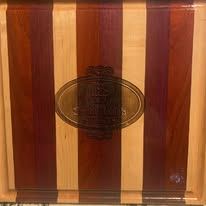 Hand-finished wood cutting board with the Sweet Rosie's Sweets logo engraved in the center